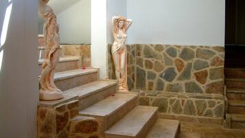 A staircase with stone steps and a stone wall.