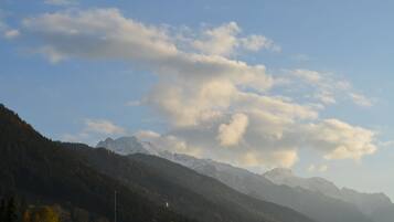 A mountainous landscape with snow-capped peaks and a clear sky.