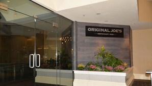 A reception area with a sign for 'Original Joe's Restaurant & Bar'. - Rosedale Condominiums (Vancouver)