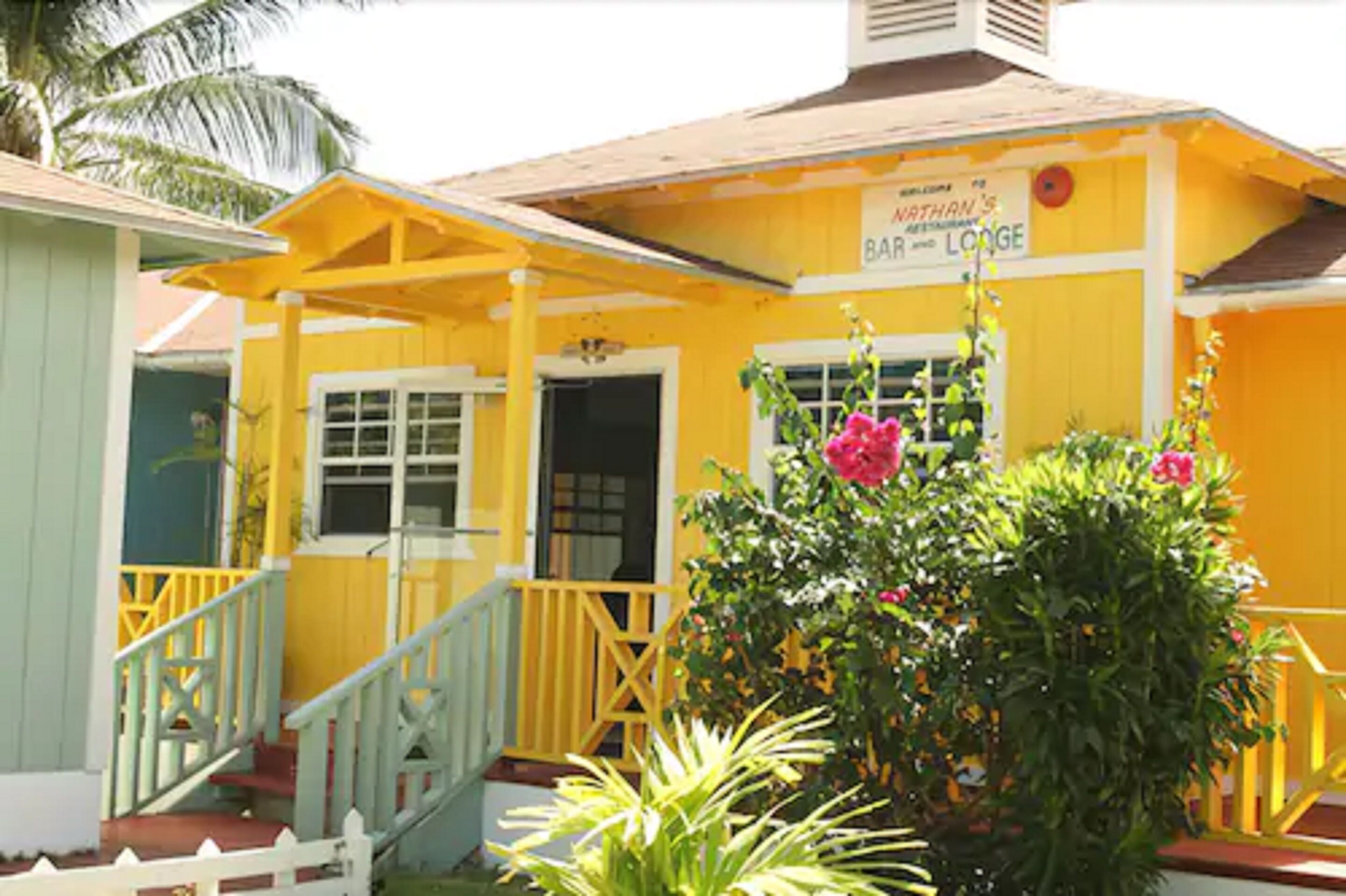 A yellow building with a sign reading "Nathan's Bar and Lodge".