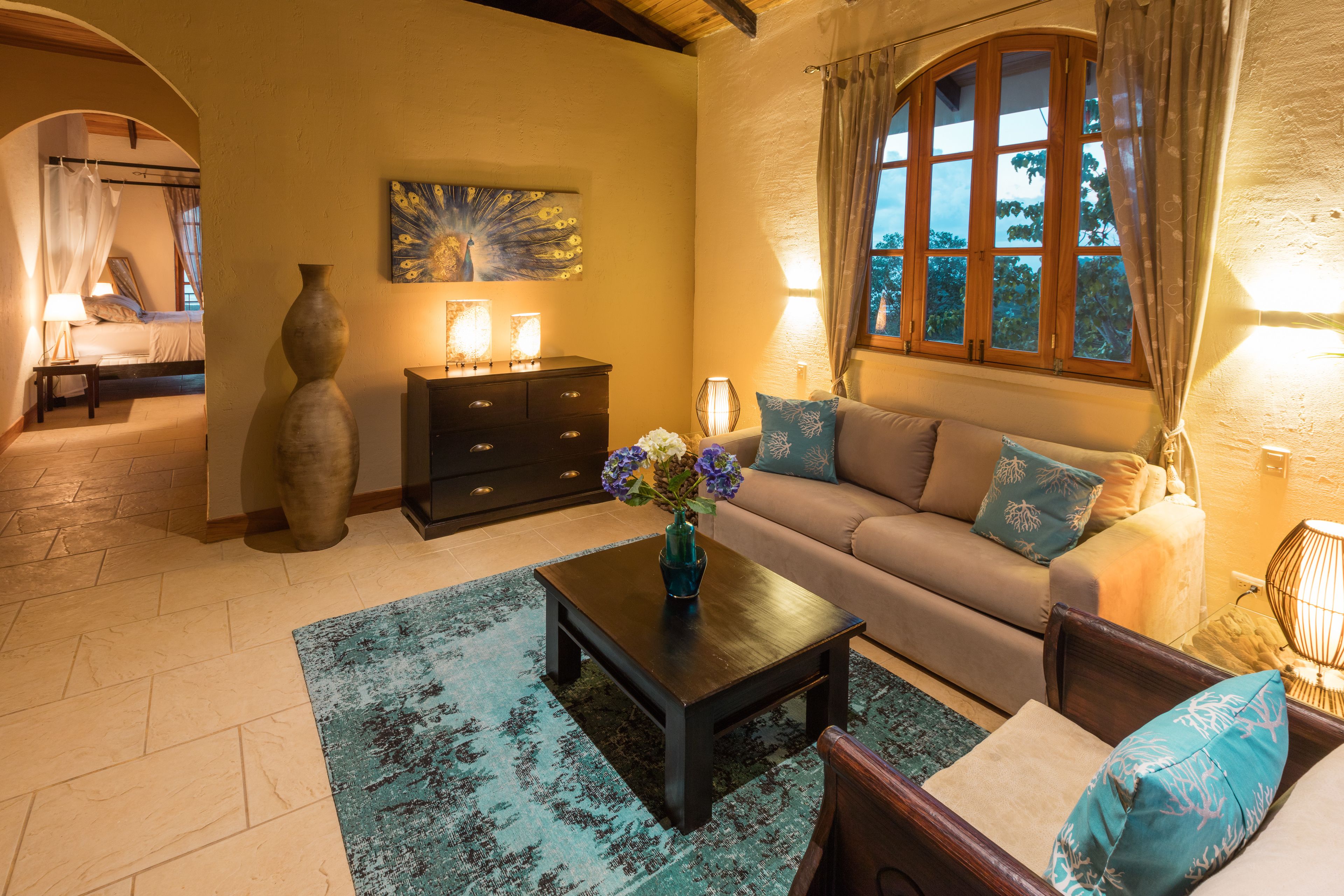A cozy living room with a sofa, coffee table, and decorative vase.