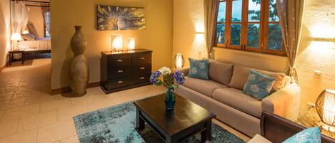A cozy living room with a sofa, coffee table, and decorative vase.