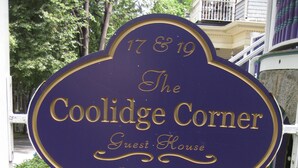 A sign for The Coolidge Corner Guest House with a website and phone number. - Coolidge Corner Guest House (Brookline)