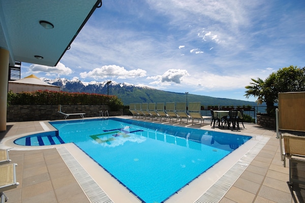 Seasonal outdoor pool, open 8:00 AM to 8:00 PM, pool umbrellas