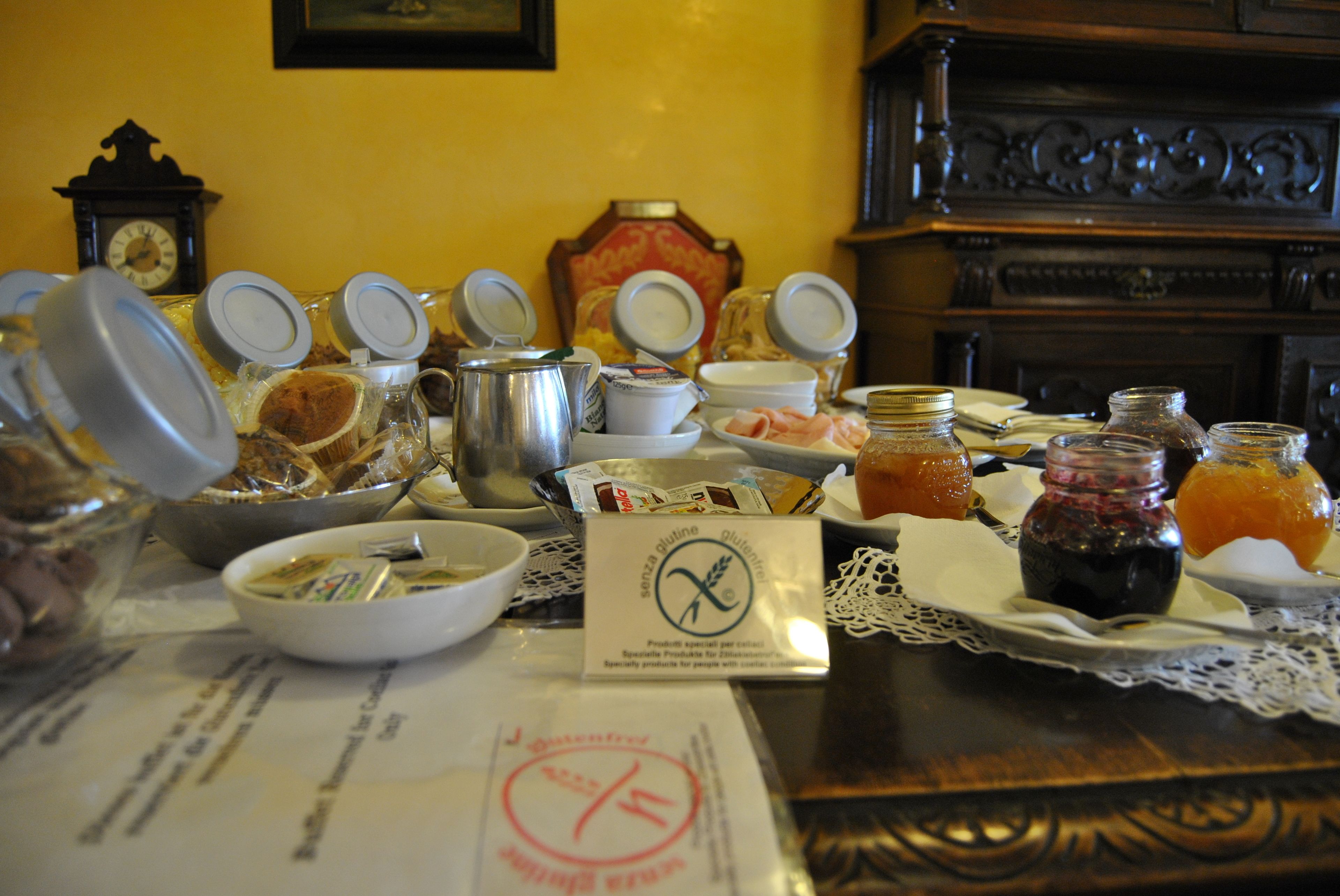 A breakfast buffet with various food items and condiments.