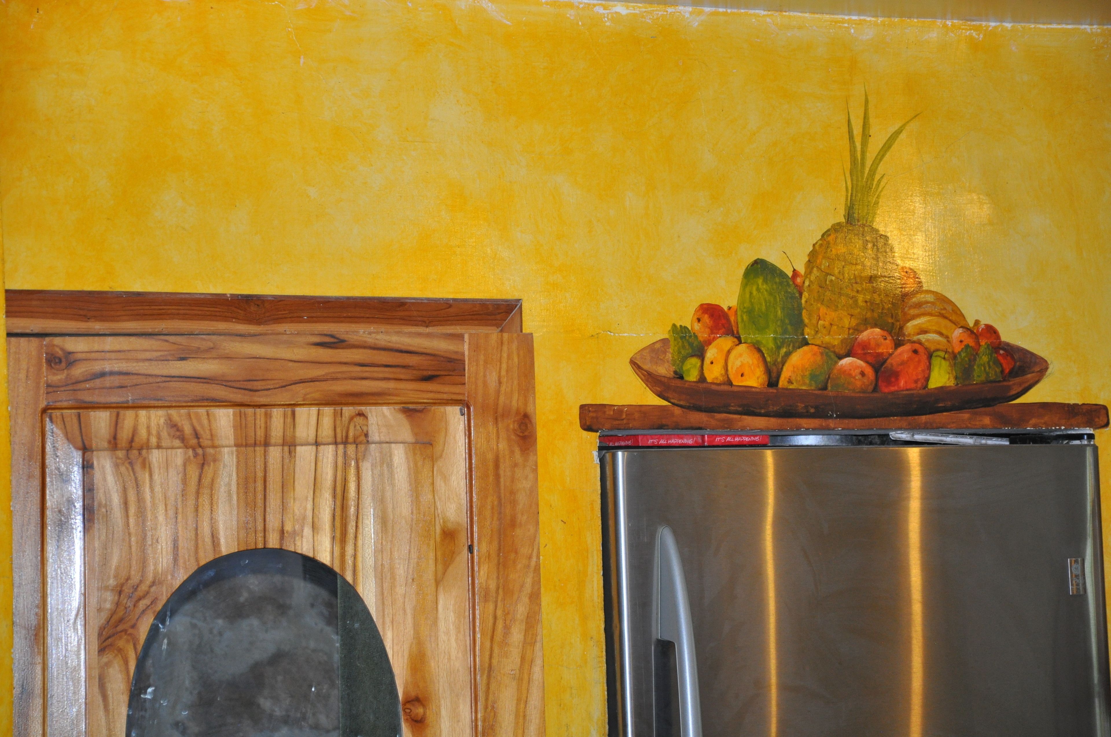 A kitchen with a wooden cabinet and a stainless steel refrigerator.