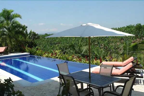 Seasonal outdoor pool, open 7 AM to 9 PM, pool umbrellas, pool loungers