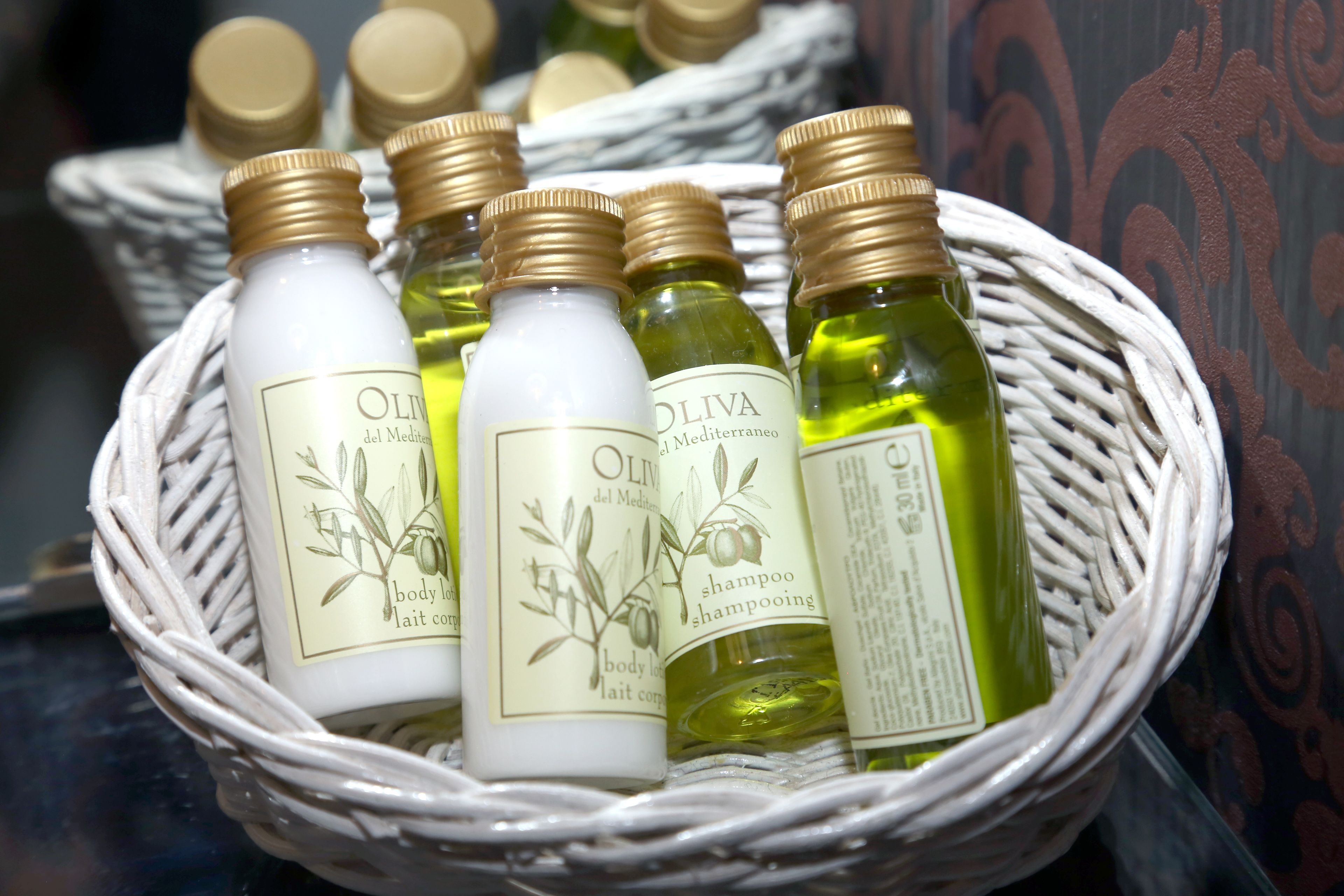 A basket containing several bottles of olive oil.