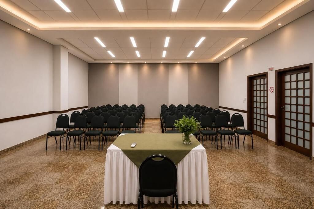 A conference room with a table, chairs, and a plant.