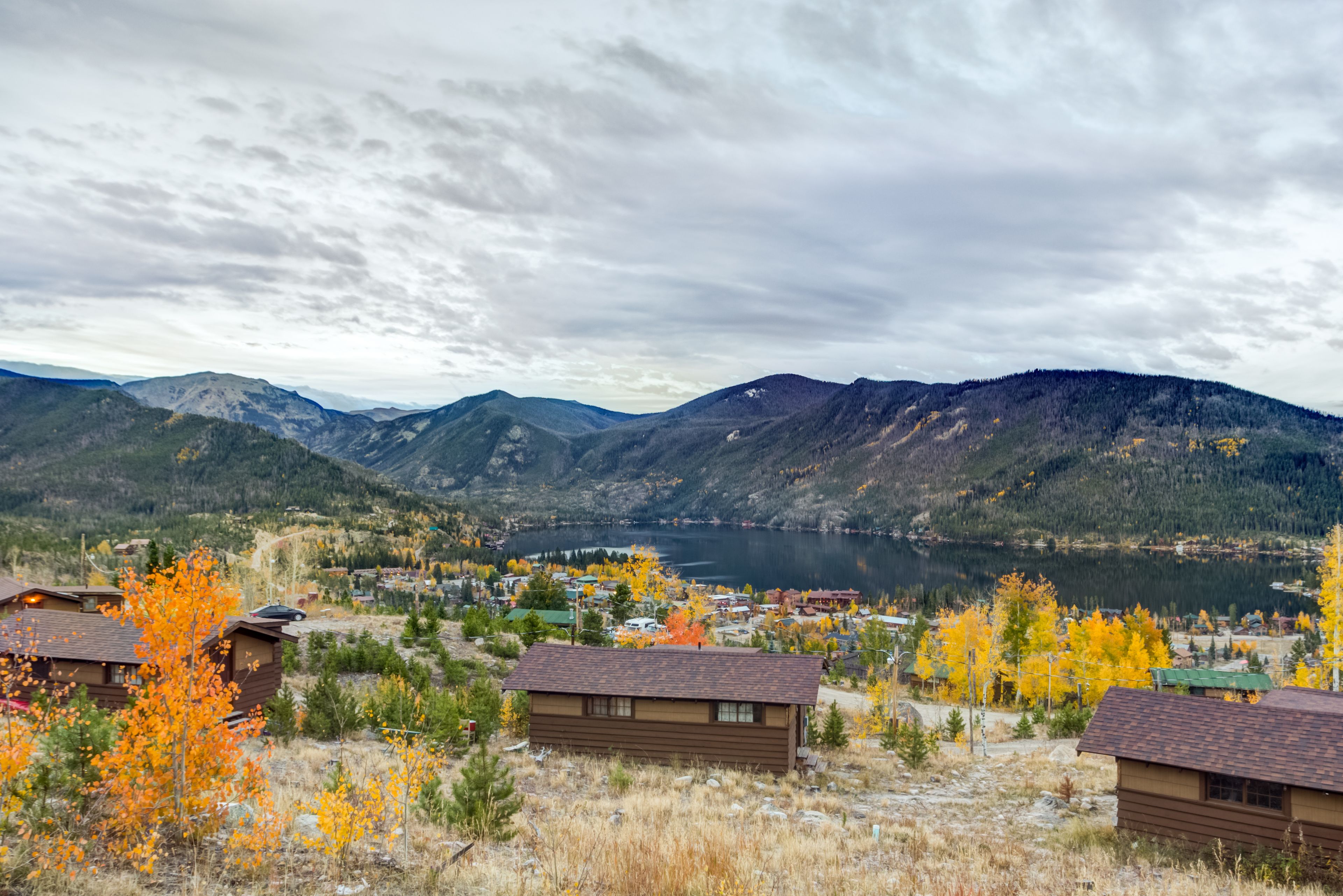 A mountainous landscape with a lake and a small town.