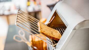 A toaster oven with a slice of bread inside.