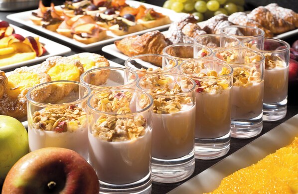 A buffet with various dishes and beverages.