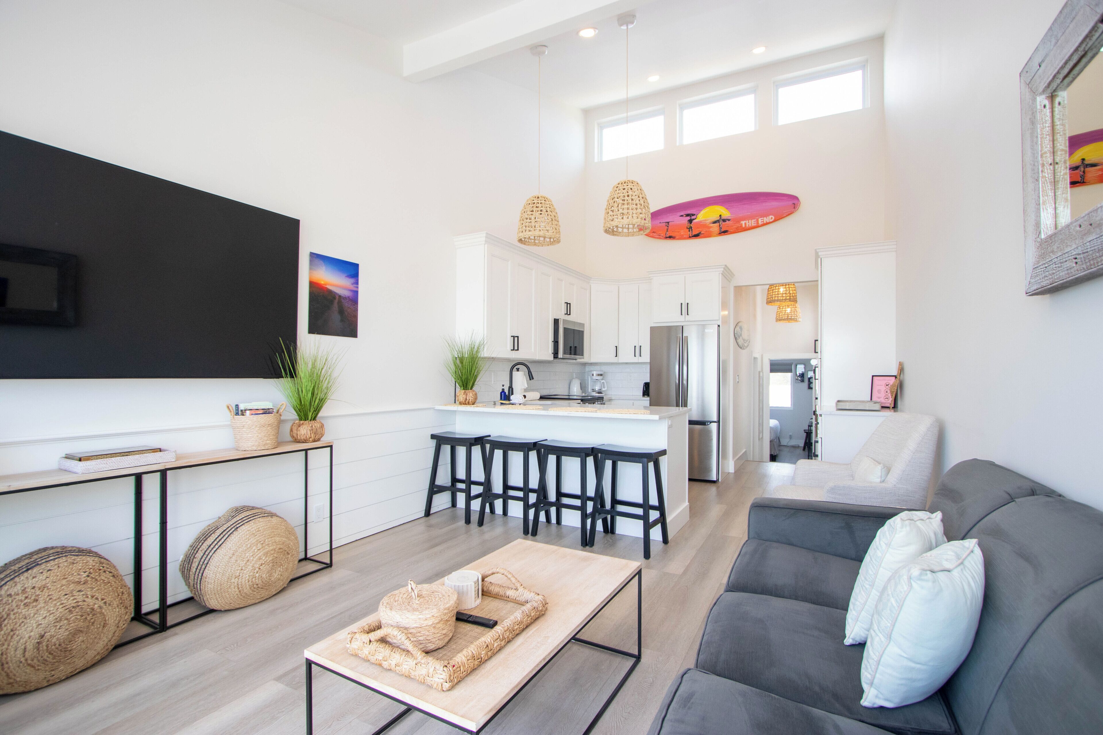 A modern living space with a kitchen, dining area, and seating area.