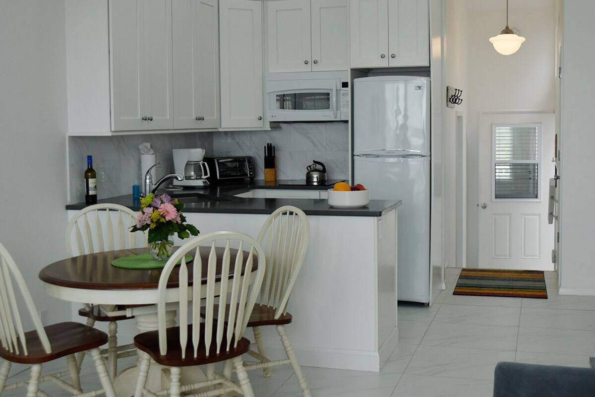 Full-sized fridge, microwave, stovetop, cookware/dishes/utensils