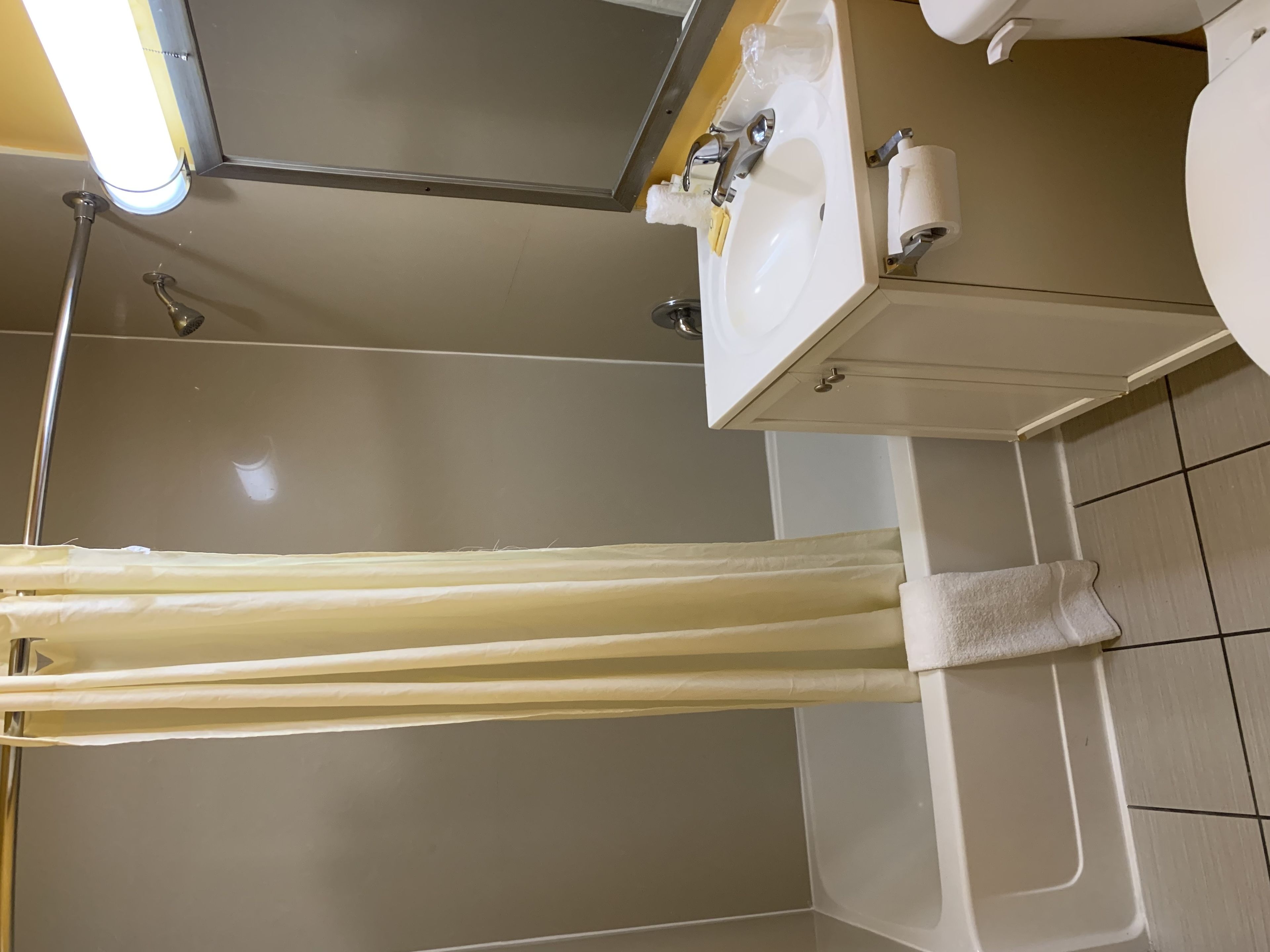 A bathroom with a bathtub, a shower, a sink, and a toilet.