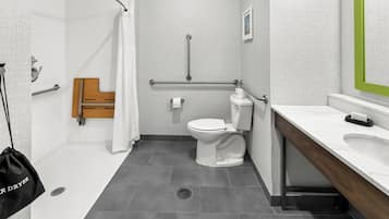 Un baño moderno con ducha, inodoro y lavamanos.