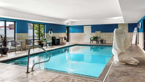 An indoor swimming pool with clear blue water, surrounded by tiled walls and a ceiling with recessed lighting. - Hampton Inn by Hilton Dayton South (Dayton)