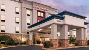 A Hampton Inn hotel with a modern facade, a covered entrance, and a brick accent wall. - Hampton Inn by Hilton Dayton South (Dayton)