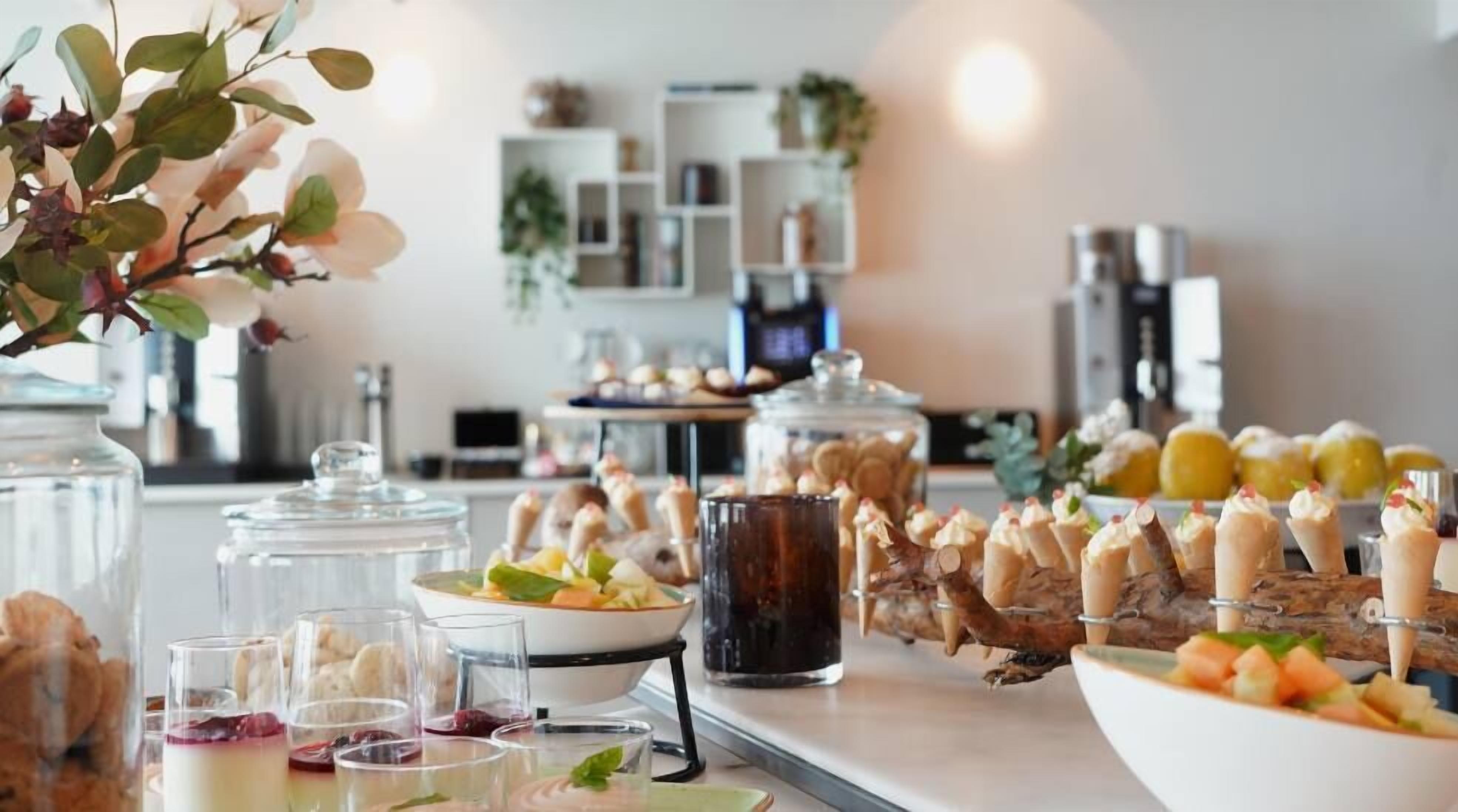 A buffet setup with various food items and drinks.