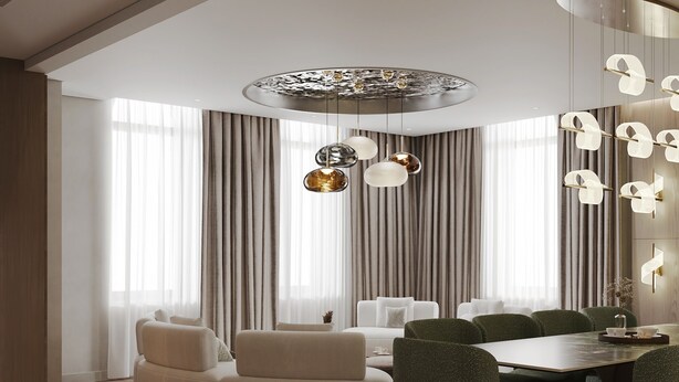 Un comedor moderno con una mesa redonda y sillas tapizadas en verde, un sofá blanco y una lámpara decorativa en el techo.