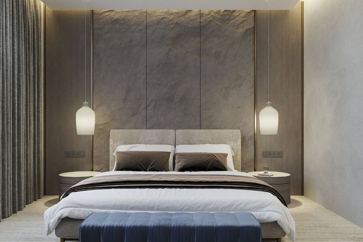 A modern bedroom with a large bed, two bedside tables, and a wall-mounted light fixture.