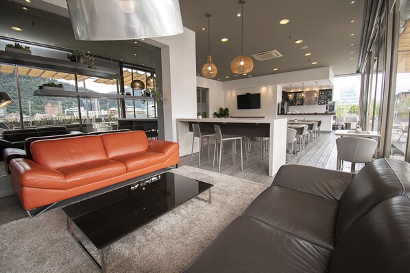 Un salon moderne avec un canapé, une table basse et un coin repas.