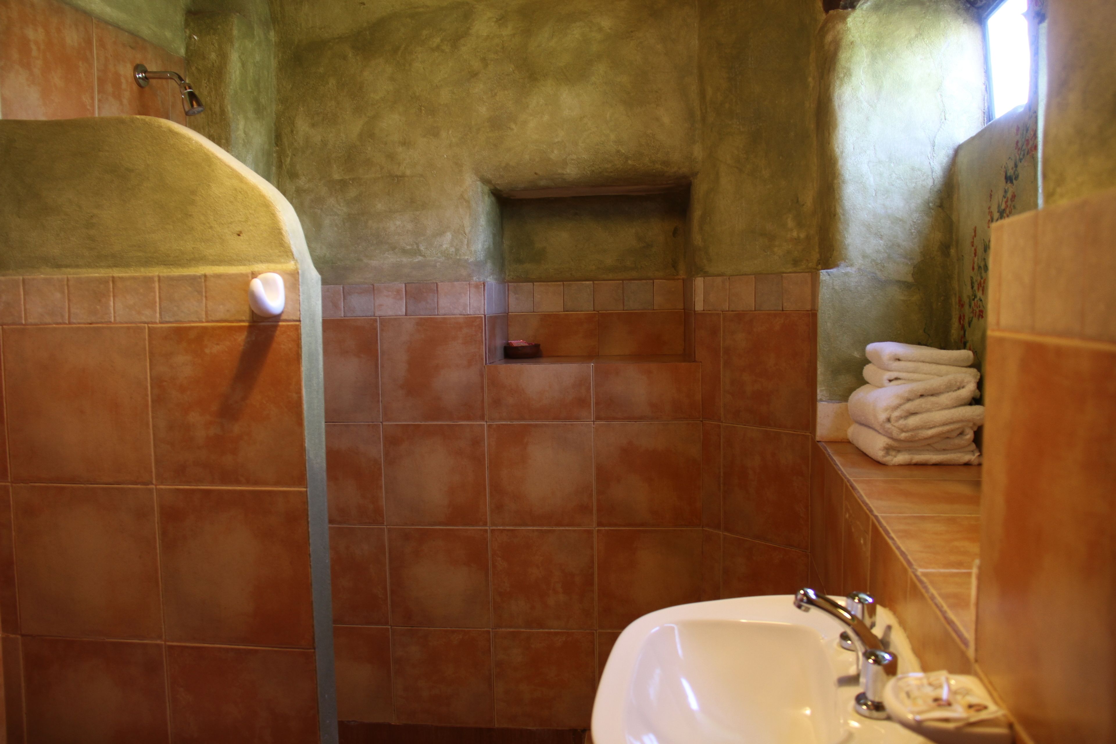 A bathroom with a bathtub, a sink, and a towel rack.