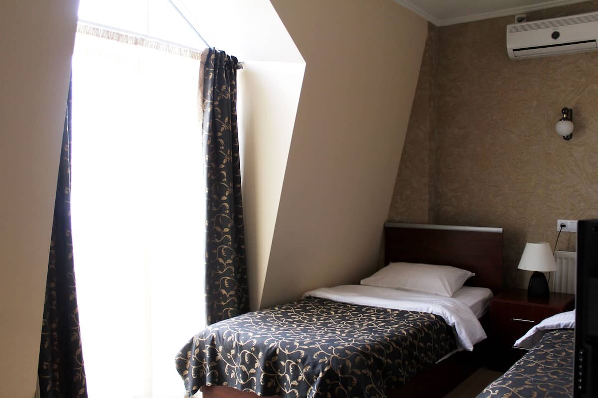 Twin Room, Private Bathroom (External) | Minibar, in-room safe, soundproofing, rollaway beds