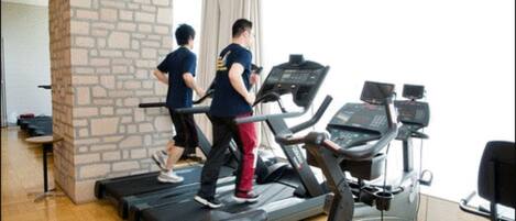 A gym with treadmills and exercise equipment.