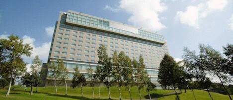 A large hotel with a modern design, featuring a flat roof and numerous windows.
