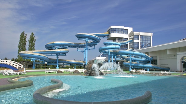 A water park with multiple slides and a pool area.