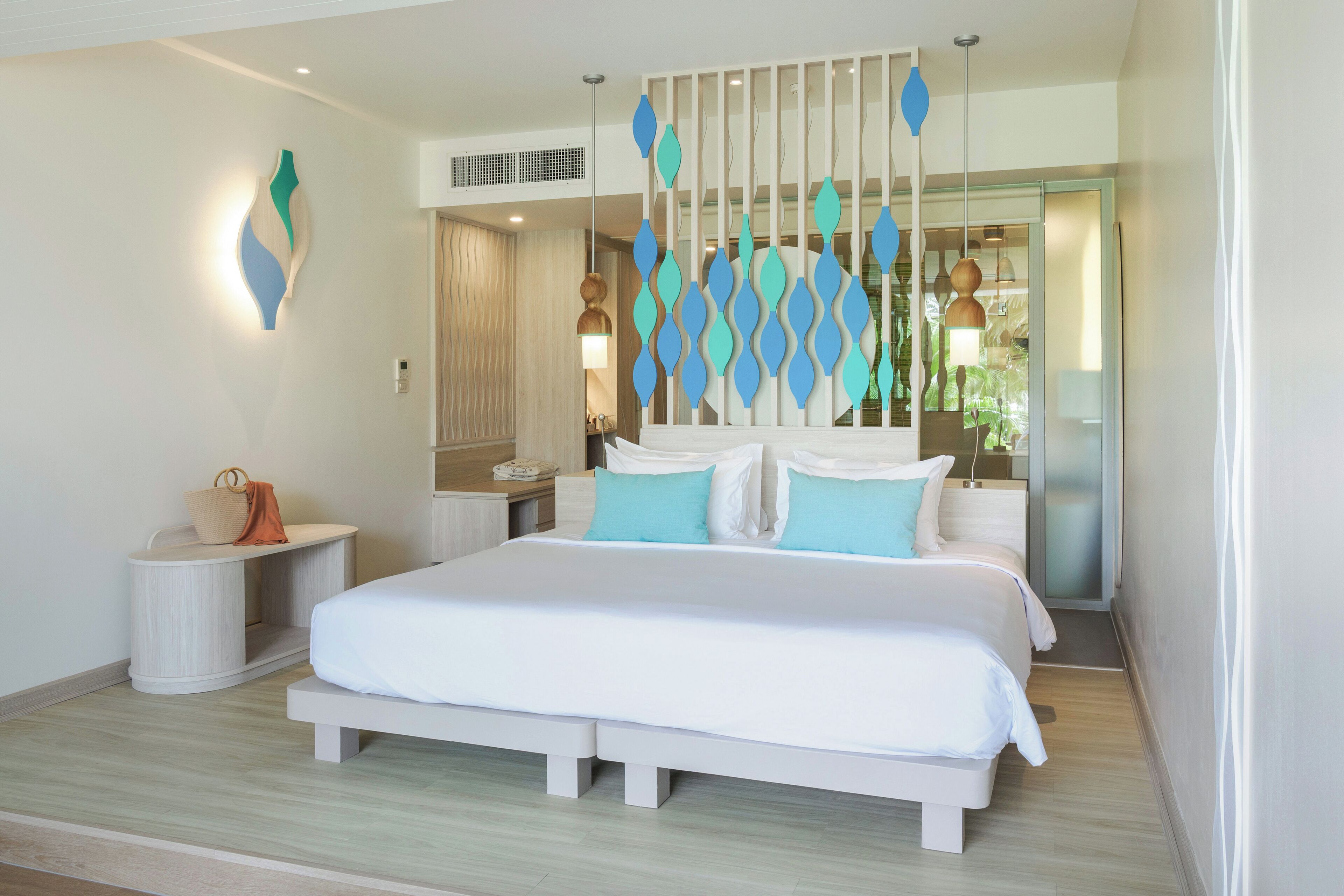 A modern bedroom with a large bed, bedside tables, and a decorative wall panel.