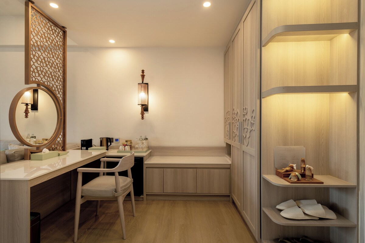 A modern bathroom with a vanity, mirror, and shelves.
