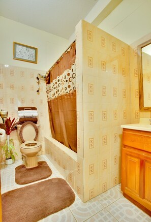Deep-soaking bathtub, rainfall showerhead, designer toiletries, towels