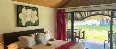 A hotel room with a bed, a large window, and a view of the outdoors.