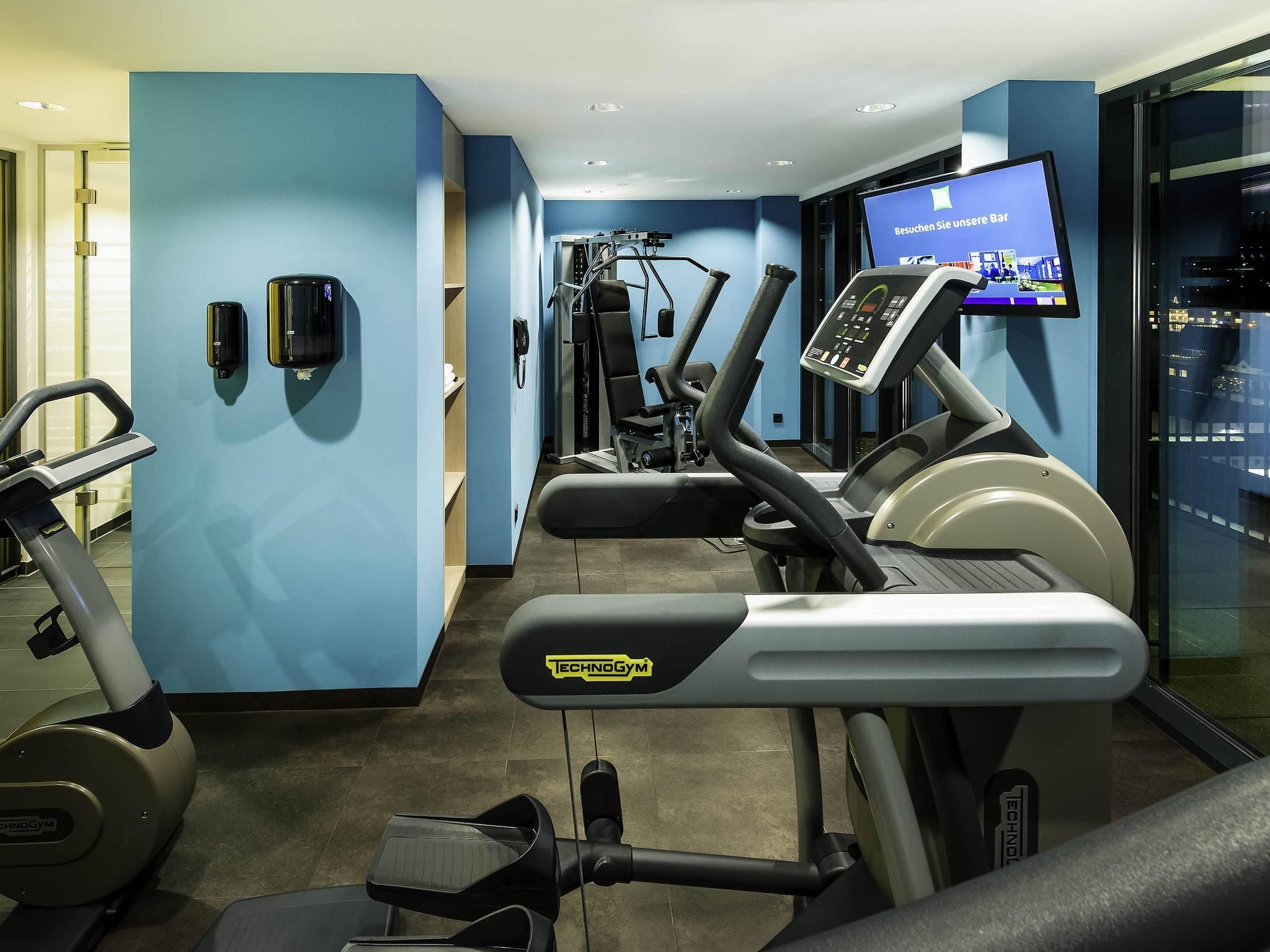 A gym with treadmills, a stationary bike, and a weight machine.