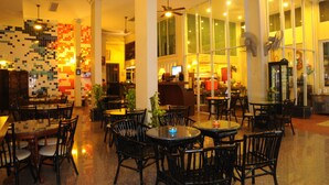 A spacious restaurant with multiple tables and chairs, large windows, and ceiling fans. - Lodge 61 Bed & Breakfast (Bangkok)