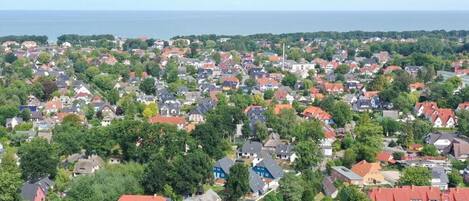 Un barrio residencial con casas, árboles y vistas al mar.