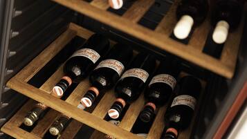 A wooden wine rack with bottles of wine.