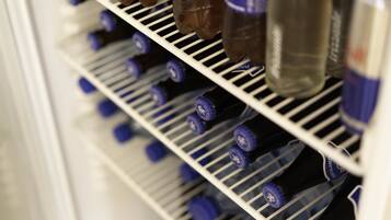 A refrigerator stocked with bottled beverages.