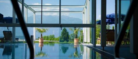 Piscine couverte, piscine extérieure, parasols de plage, chaises longues
