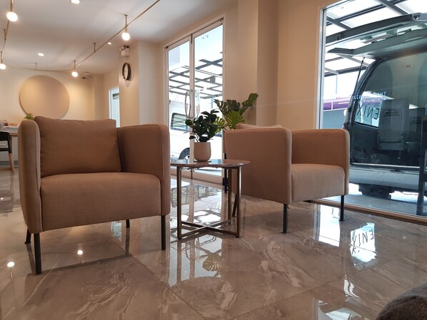 A modern interior with a sofa, a small table, and a potted plant.