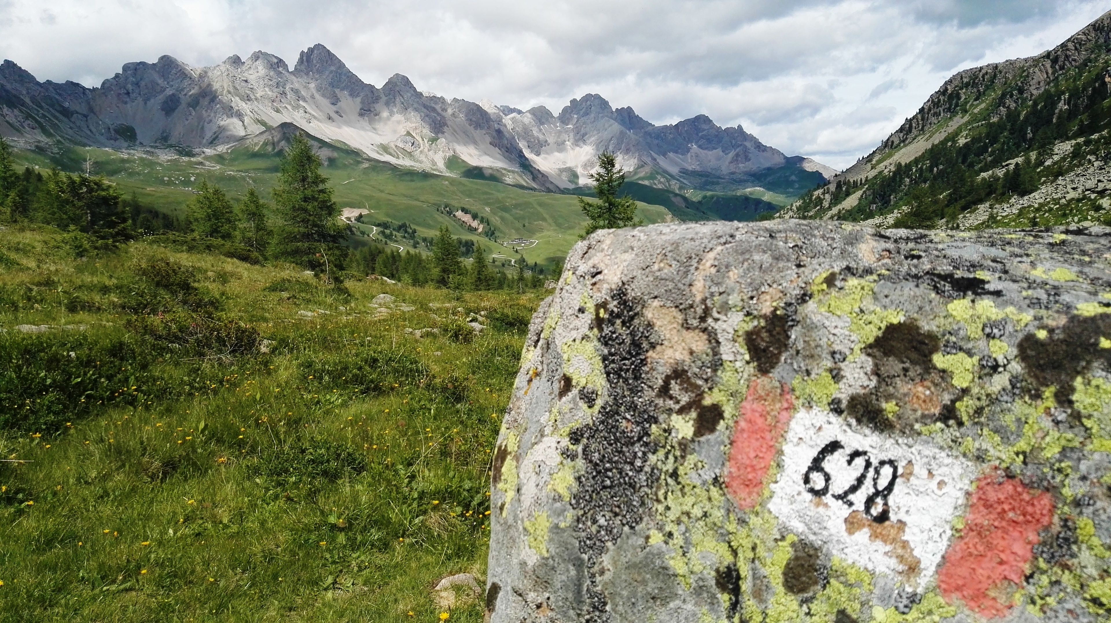 A mountain landscape with a rocky outcrop in the foreground marked with the number 628.