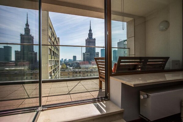 A balcony with a view of a cityscape, including a prominent building with a spire. - Exclusive Apartments Warsaw City Centre (Warsaw)