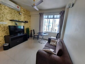 Comfort Suite | Living area | 26-inch LCD TV with satellite channels, TV, streaming services