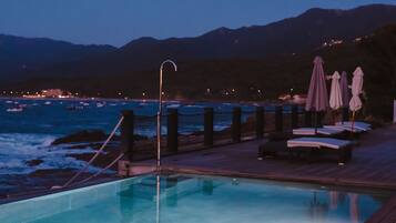 Seasonal outdoor pool, open 9 AM to 7:00 PM, pool umbrellas
