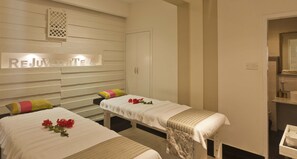 A spa room with two beds, a reception area, and a mirror. - Escape Hotel & Spa (Bengaluru)