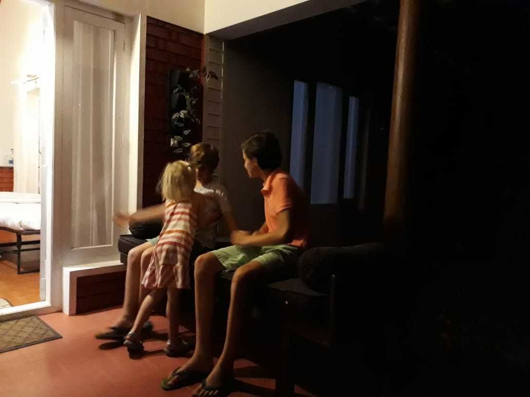 A room with a bed, a chair, and a table.