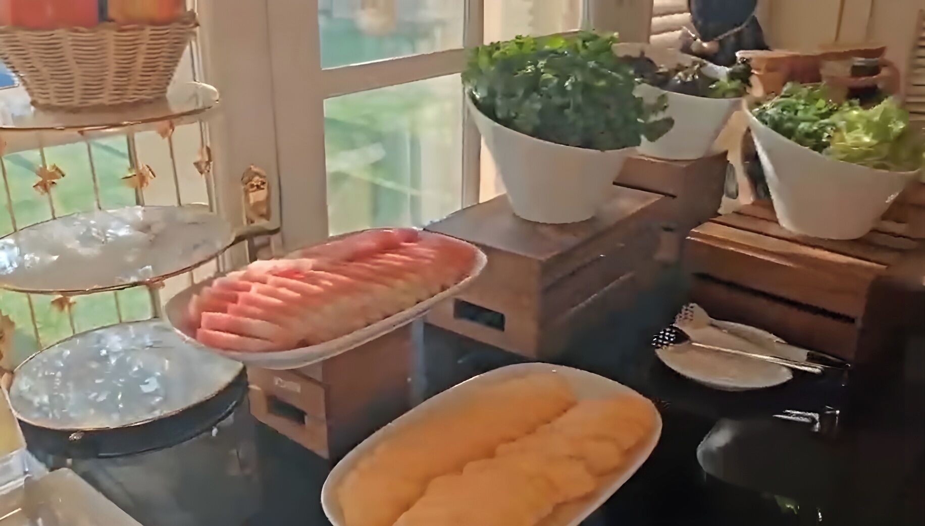 Una mesa de buffet con diferentes platos y una planta en maceta.