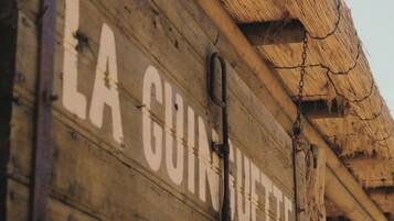 A wooden sign with the text "LA GUINOUETTE" indicating the name of a location or establishment.